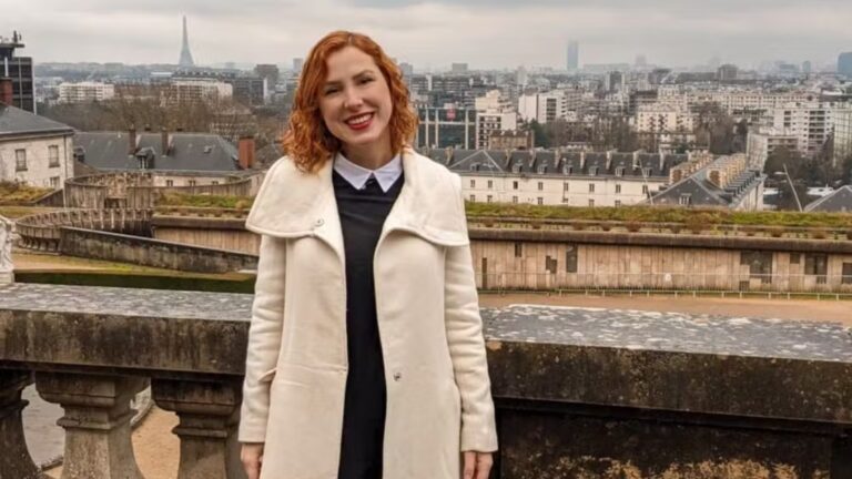 Foto de influenciadora Fernanda Lind em frente a paisagem clássica de Paris