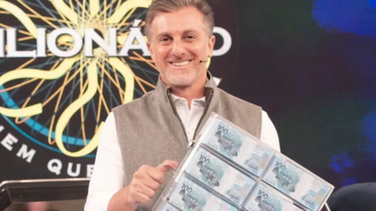 Foto de Luciano Huck segurando várias notas de R$ 100