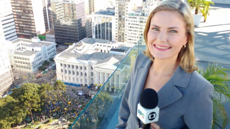 Foto de Ana Zimmerman segurando microfone da Globo